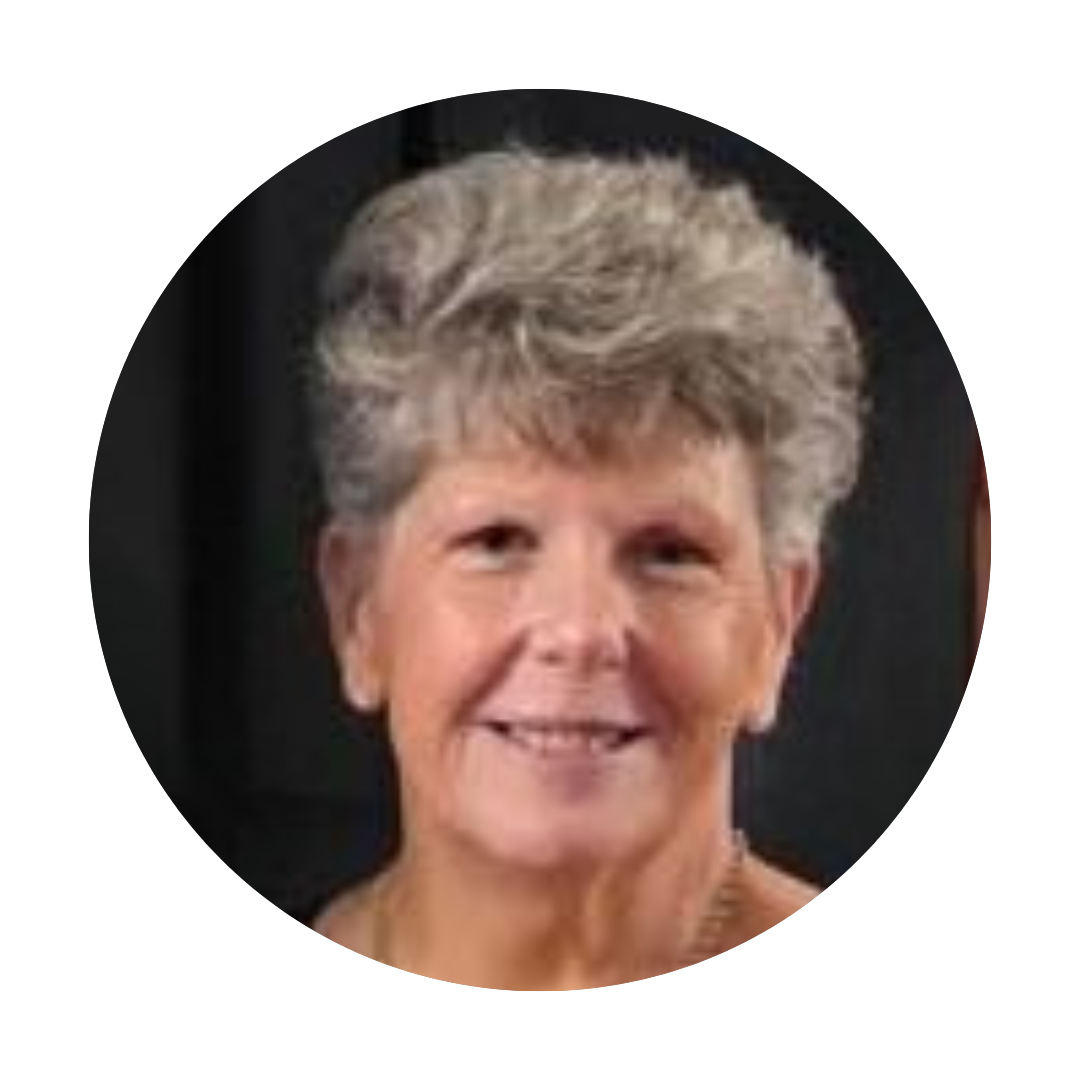 Sarah Lee, a woman with short greyish hair against a dark background